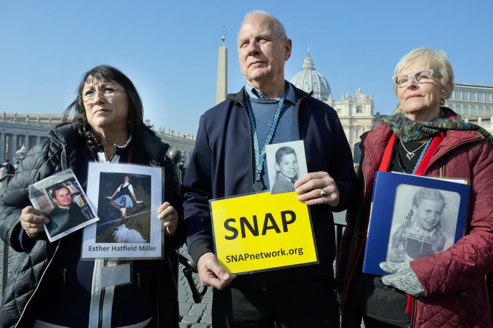 Survivors Network of those Abused by Priests (SNAP) President Tim Lennon from Tucson, Ariz., center, and SNAP members Esther Hatfield Miller from Los Angeles, Calif., left, and Carol Midboe from Austin, pose for pictures during interviews with the media in St. Peter's Square at the Vatican during Pope Francis' general audience, Wednesday, Feb. 20, 2019. Organizers of Pope Francis' summit on preventing clergy sex abuse met with a dozen survivor-activists who have come to Rome to protest the Catholic Church's response to date and demand an end to decades of cover-up by church leaders. (AP Photo/Luigi Navarra)