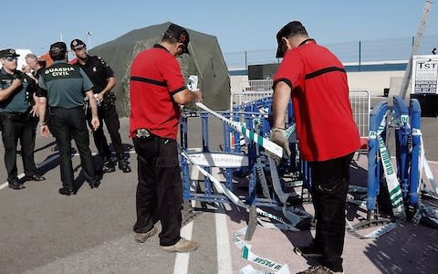 Spanish Guardia Civil guard and Emergency Services members set fences at Valencia's harbour - Credit: AFP