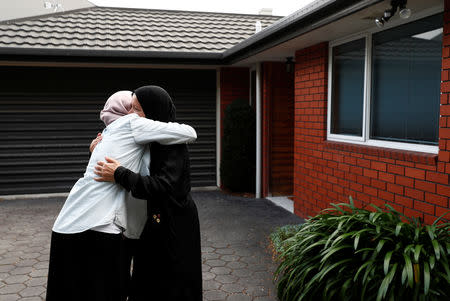 Zahra Fathy, widow of 70-year-old Hussein Moustafa, an Egyptian immigrant who lost his life in the Christchurch shootings, embraces a neighbor who came to check on how Zahra was coping, outside her house in Christchurch, New Zealand March 30, 2019. REUTERS/Edgar Su