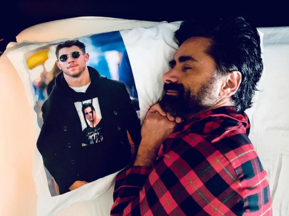 John Stamos with a Nick Jonas pillow | John Stamos/Instagram