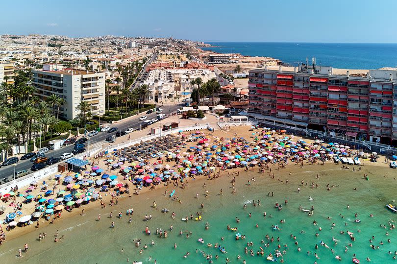 Aerial panoramic view of beach and Torrevieja cityscape.