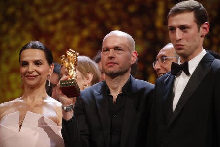 Nadav Lapid with Golden Bear for Best Film , president of the International Jury Juliette Binoche and actor Tom Mercier pose after the awards ceremony at the 69th Berlinale International Film Festival in Berlin, Germany, February 16, 2019. REUTERS/Hannibal Hanschke