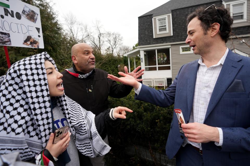 Two men, a pro-Palestinian demonstrator, (left, background) and a pro-Israeli demonstrator (right), were having a peaceful discussion in Teaneck until others joined the conversation and threats were made to the man on the right. Police had to escort him out of the area, Sunday, March 10, 2024.