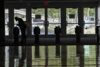 A delegate from Madagascar swipes his ID to enter the building during the 75th session of the United Nations General Assembly, Wednesday, Sept. 23, 2020, at U.N. headquarters. This year's annual gathering of world leaders at U.N. headquarters will be almost entirely "virtual." Leaders have been asked to pre-record their speeches, which will be shown in the General Assembly chamber, where each of the 193 U.N. member nations are allowed to have one diplomat present. (AP Photo/Mary Altaffer)