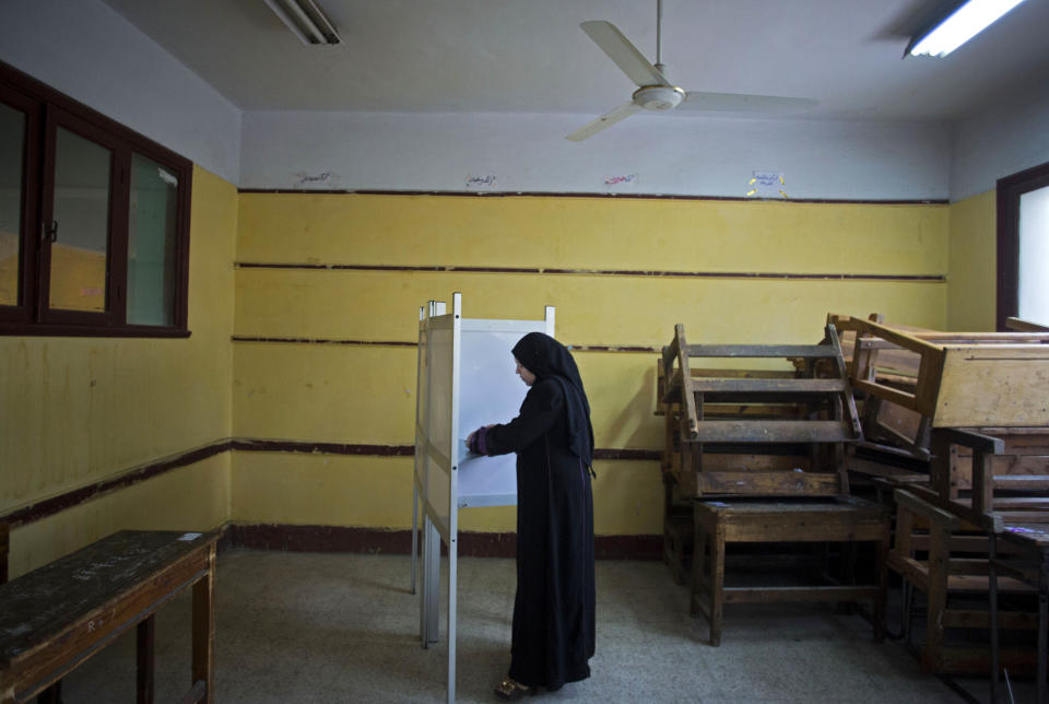 FILE - In this file photo taken Tuesday, Jan. 14, 2014, an Egyptian woman votes in the country's constitutional referendum in Cairo, Egypt. The country's presidential election will be held in late May, the electoral commission announced on Sunday, March 30, finally setting dates for the crucial vote widely expected to be won by the country's former military chief who ousted an elected president last year. (AP Photo/Khalil Hamra, File)