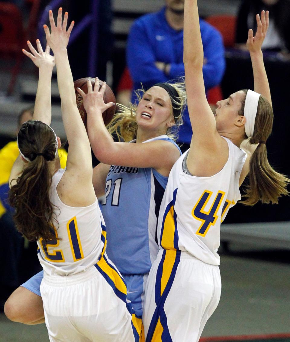 Superior's Jessica Lindstrom (21) is double-teamed by Mukwonago's Ellie Michalski (21) and Morgan Glatczak (44) during the first half of their Division 1 semifinal in the WIAA state girls basketball tournament Friday, March 21, 2014, at the Resch Center in Ashwaubenon.