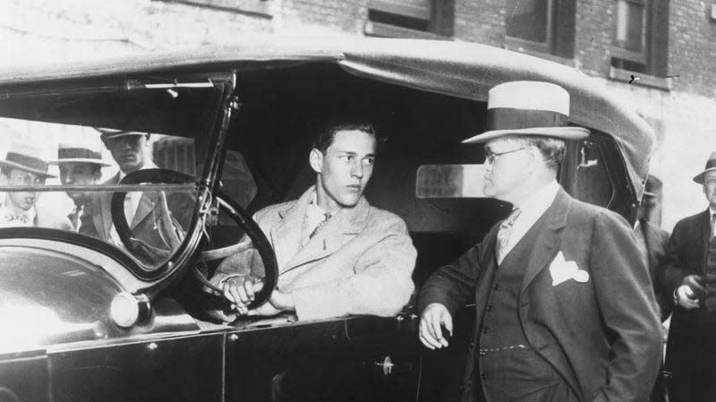 Richard Loeb, one of the youthful confessed slayers of Robert franks, at the wheel of the car used in spiriting away 13 year old Robert Franks. Standing beside the car is state attorney, Robert Crowe, in charge of the prosecution. Loeb and Nathan Leopold posed for photographers of the prosecution. Loeb and Nathan Leopold posed for photographers while at the wheel of the car but refused to be pictured together. - Image: Getty (Getty Images)