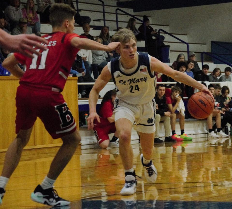 Brody Jeffers looks to drive during a boys basketball matchup between Gaylord St. Mary's and Bellaire on Tuesday, February 7.