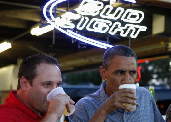 President Barack Obama shares a beer with Mike Cunningham II at a beer stand at the Iowa State Fair, August 13, 2012.