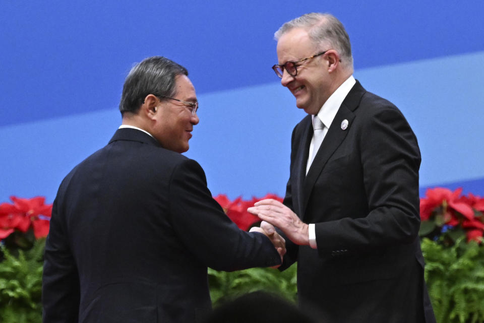 China's Premier Li Qiang, left, greets Australia's Prime Minister Anthony Albanese during the China International Import Expo opening session in Shanghai, China, Sunday, Nov. 5, 2023. Albanese will hold talks in China with President Xi Jinping in the first visit to the Asian nation by a sitting prime minister since 2016. (Lukas Coch/AAP Image via AP)