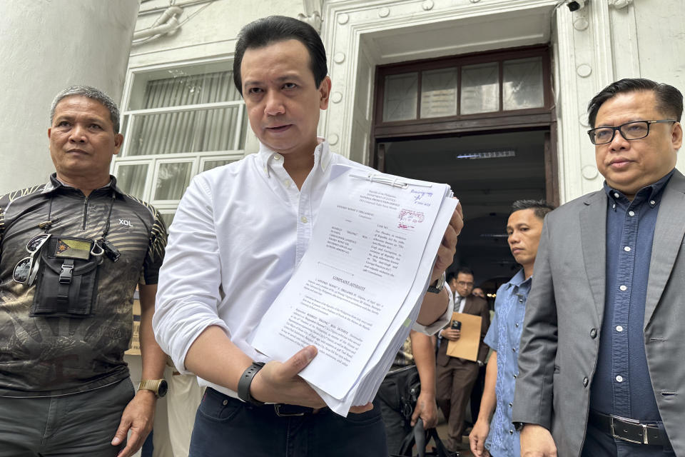 Former Sen. Antonio Trillanes shows documents to reporters after filing at the Department of Justice in Manila, Philippines on Friday July 5, 2024. Trillanes filed criminal complaints of economic plunder against ex-President Rodrigo Duterte Friday over alleged anomalies in the awarding of large numbers of government infrastructure projects worth billions of pesos (millions of dollars) to two companies when he was a southern city mayor and later as president. (AP Photo/Joeal Calupitan)