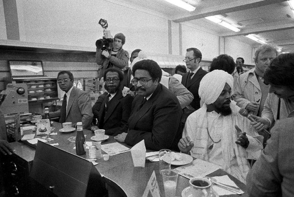 FILE - In a Feb. 1, 1980 file photo, former North Carolina A & T students, left to right, Joseph McNeill, David Richmond, Franklin McCain and Jibreel Khazan, sit at the F.W. Woolworth lunch counter in Greensboro, N.C., as they celebrate the 20th anniversary of their historic sit-in. The four were not served in 1960 but their action launched the sit-in movement in more than nine states. (AP Photo/Bob Jordan, File)