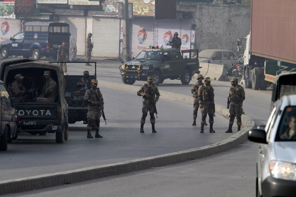 Pakistani army troops secure a road leading to the site of a suicide bombing in Rawalpindi, Pakistan, Monday, Jan. 20, 2014. A Taliban suicide bomber blew himself up not far from Pakistan’s military headquarters Monday, killing nine people a day after a militants bombing inside an army compound in the northwest of the country, officials and militants said. (AP Photo/Anjum Naveed)