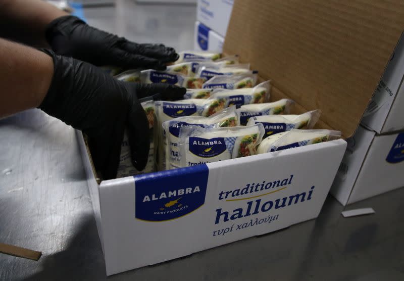 A worker packs halloumi cheese at the Petrou Bros Dairy in Aradippou,