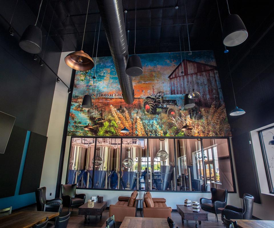 The new Cold Harbor Brewing Co. dining area features a mural depicting the original Red's Farm on the site, as well as a view into the beer brewing tanks, Aug. 2, 2023.