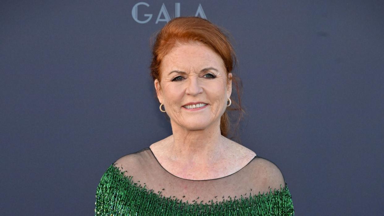 Sarah Ferguson smiling in glitzy green dress