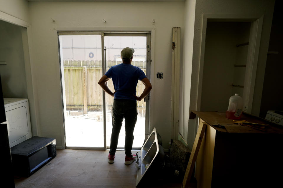 A rafter from Cuba who recently arrived in Miami illegally by sea, seeking to escape political and economic difficulties, is seen at a worksite, Wednesday, July 6, 2022, in Austin, Texas. (AP Photo/Eric Gay)