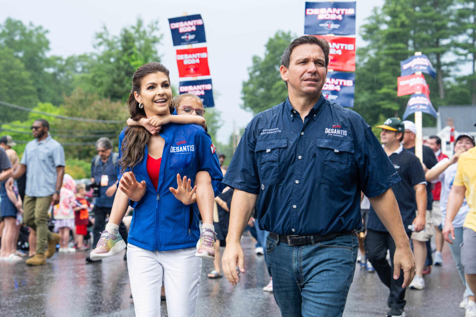 Ron DeSantis, governor of Florida, center, and Casey DeSantis, Florida's first lady, left, attend the Independence Day parade in Merrimack, New Hampshire, US, on Tuesday, July 4, 2023.   / Credit: Mel Musto/Bloomberg via Getty Images