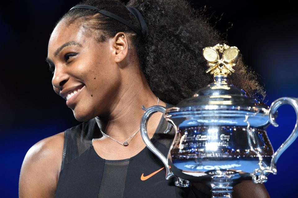 Serena Williams of the US holds up the trophy following her victory over Venus Williams of the US in the women's singles final: PAUL CROCK/AFP/Getty Images