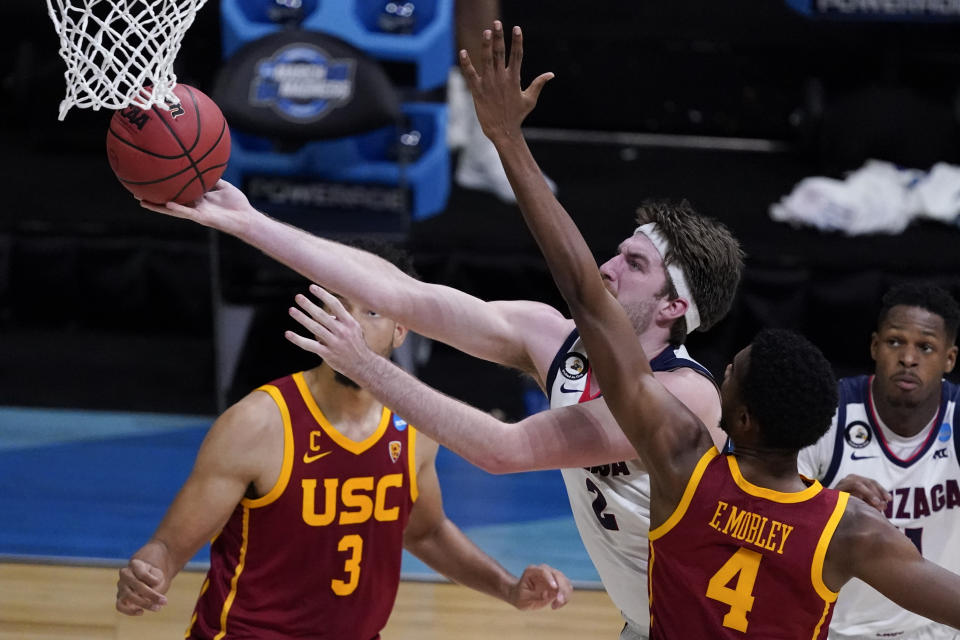 Gonzaga forward Drew Timme drives to the basket ahead of Southern California forward Evan Mobley (4) during the second half of an Elite 8 game in the NCAA men's college basketball tournament at Lucas Oil Stadium, Tuesday, March 30, 2021, in Indianapolis. (AP Photo/Darron Cummings)