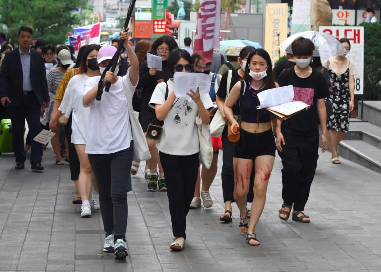 South Korean women participating in a protest to urge tech giants including Google, Youtube, Facebook and Twitter to work harder to curb high-tech sex crimes in Seoul