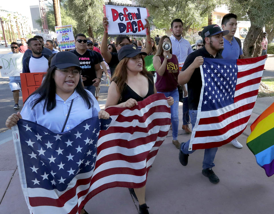 FILE - In this Sept. 5, 2017, file photo, Deferred Action for Childhood Arrivals (DACA) supporters march to the Immigration and Customs Enforcement office to protest shortly after U.S. Attorney General Jeff Sessions' announcement that DACA will be suspended with a six-month delay in Phoenix. The 2020 election campaigns are heating up as the Supreme Court prepares to decide the future of DACA, which President Donald Trump wants to end. (AP Photo/Matt York, File)
