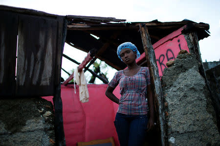 Carine Louis-Jean, 22, poses for a photograph in her destroyed house after Hurricane Matthew hit Jeremie, Haiti, October 17, 2016. "The roof of my house is completely gone and some of walls were destroyed. I have lost everything I had, but I thank God that I have a friend who is letting me stay at her house. I could say I'm lucky, because none of my family died during the hurricane, but I do not think I'm lucky," said Louis-Jean. REUTERS/Carlos Garcia Rawlins