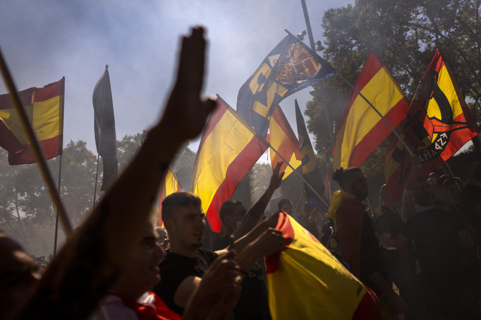 Protesters make the fascist salute as ultra right wing protesters march during an alternative celebration for Spain's National Day in Barcelona, Spain, Tuesday, Oct. 12, 2021. Spain commemorates Christopher Columbus' arrival in the New World and also Spain's armed forces day. (AP Photo/Emilio Morenatti)