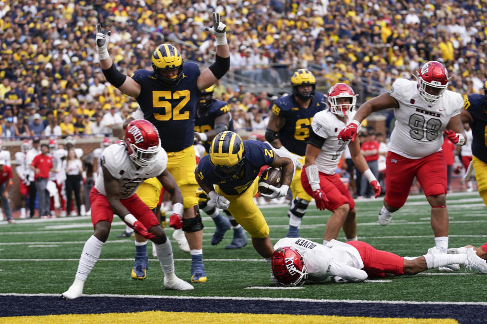 Michigan running back Blake Corum (2) scores on a two-yard touchdown run against UNLV in the second half of an NCAA college football game in Ann Arbor, Mich., Saturday, Sept. 9, 2023. (AP Photo/Paul Sancya)