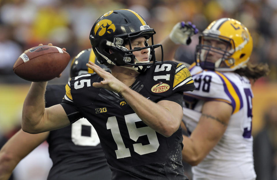 Iowa quarterback Jake Rudock (15) throws a pass despite pressure from LSU defensive end Jordan Allen (98) during the second quarter of the Outback Bowl NCAA college football game Wednesday, Jan. 1, 2014, in Tampa, Fla. (AP Photo/Chris O'Meara)