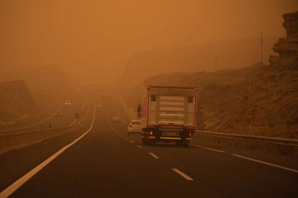 Cars drive on the TF-1 highway during a sandstorm in Santa Cruz de Tenerife, on the Canary Island of Tenerife, on February 23, 2020.