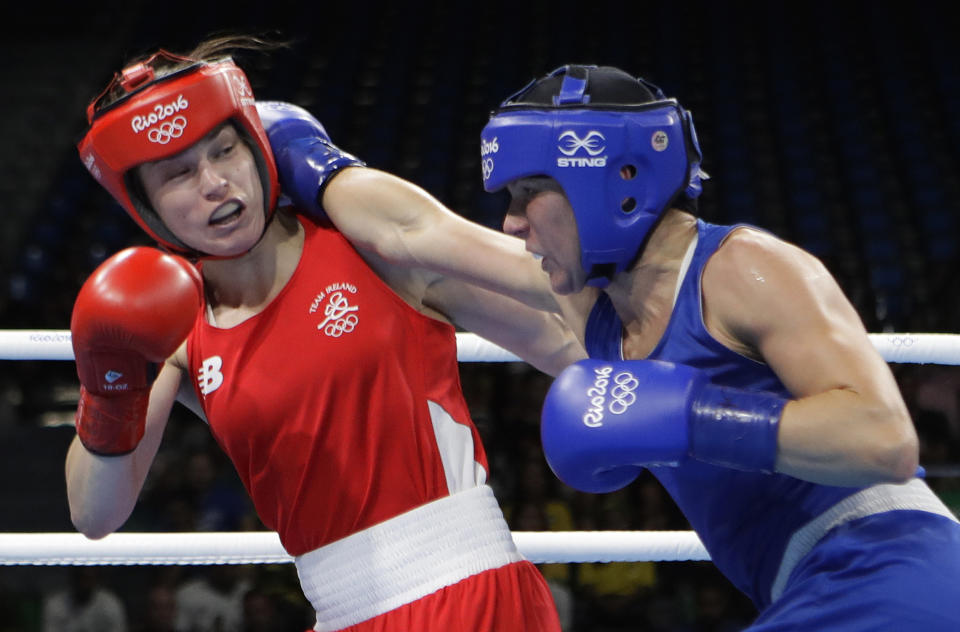 FILE - Finland's Mira Potkonen, right, fights Ireland's Katie Taylor during a women's lightweight 60-kg quarterfinals boxing match at the 2016 Summer Olympics in Rio de Janeiro, Brazil, on Aug. 15, 2016. Katie Taylor and Claressa Shields have used their Olympic success as a springboard into the pro ranks — headlining cards, selling out big arenas and garnering more media attention to help push the women's game into the mainstream. (AP Photo/Frank Franklin II, File)