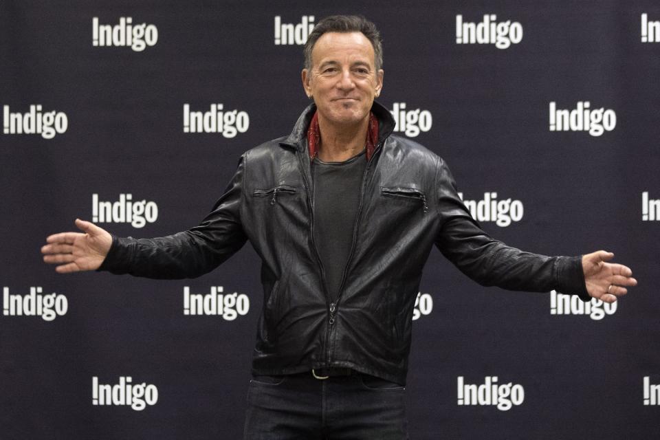 FILE - In this Oct. 27, 2016, file photo, Bruce Springsteen greets fans in a book store as he promotes his new book "Born to Run" in Toronto. While it takes Springsteen close to four hours to effectively revisit the four-plus decades of his career in concert, the Boss needed just 90 minutes to chronicle his life story at New Jersey's Monmouth University. The 67-year-old Garden State-born rocker spoke at the school in West Long Branch Tuesday night, Jan. 10, 2017, as part of an "intimate conversation" moderated by Grammy Museum Executive Director Bob Santelli. (Chris Young/The Canadian Press via AP)