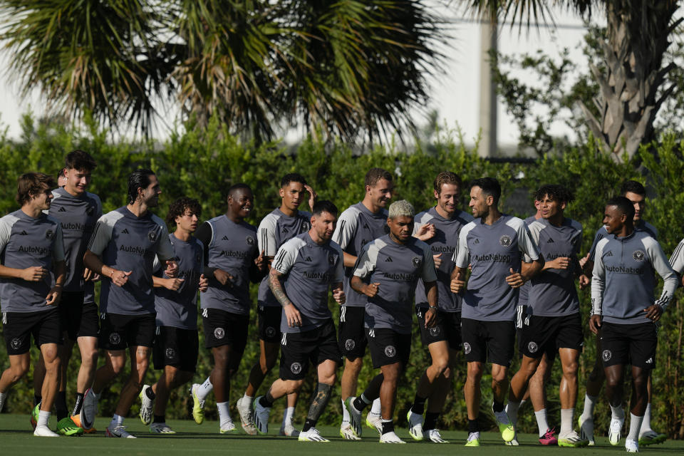 Lionel Messi, center left, jogs alongside forward Josef Martinez, center right, as the team warms up at the start of a training session for the Inter Miami MLS soccer team Tuesday, July 18, 2023, in Fort Lauderdale, Fla.(AP Photo/Rebecca Blackwell)