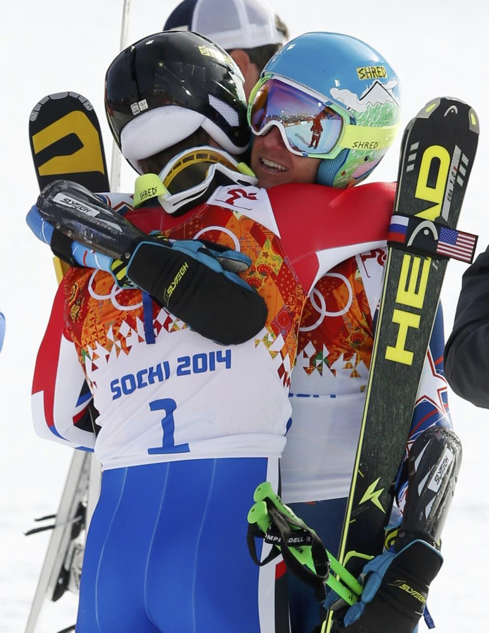 Winner Ted Ligety of the U.S. (R) hugs third-placed France's Alexis Pinturault after the second run of the men's alpine skiing giant slalom event in the Sochi 2014 Winter Olympics at the Rosa Khutor Alpine Center February 19, 2014. REUTERS/Mike Segar (RUSSIA - Tags: OLYMPICS SPORT SKIING)