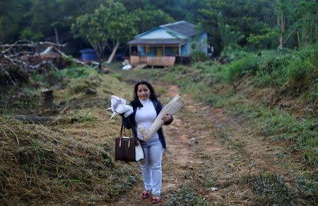 Antonia Marcelino, 51, carries a handmade wooden leg, a symbol of grace, during an annual celebration in Chico Mendes Extraction Reserve in Xapuri, Acre state, Brazil, June 24, 2016. REUTERS/Ricardo Moraes