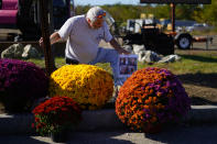 Richard Morlock, a member of the deaf community and surviver of the mass shooting at Schemengees Bar and Grille, pays his respect at a makeshift memorial to his friends he played cornhole with who were killed during the recent mass shooting in Lewiston, Maine, Saturday, Oct. 28, 2023. (AP Photo/Matt Rourke)