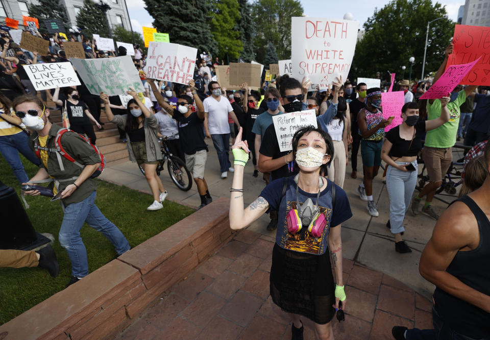 Participants march during a protest outside the State Capitol over the death of George Floyd, a handcuffed black man in police custody in Minneapolis, Thursday, May 28, 2020, in Denver. Close to 1,000 protesters walked from the Capitol down the 16th Street pedestrian mall during the protest. (AP Photo/David Zalubowski)