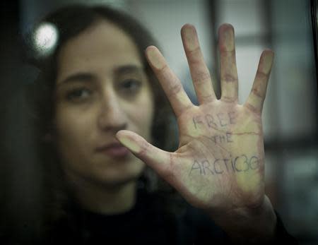 Greenpeace International activist Faiza Oulahsen of the Netherlands displays a message on her palm during a bail hearing at the Murmansk Regional Court, in this Greenpeace handout picture on October 18, 2013. REUTERS/Dmitri Sharomov/Greenpeace/Handout via Reuters