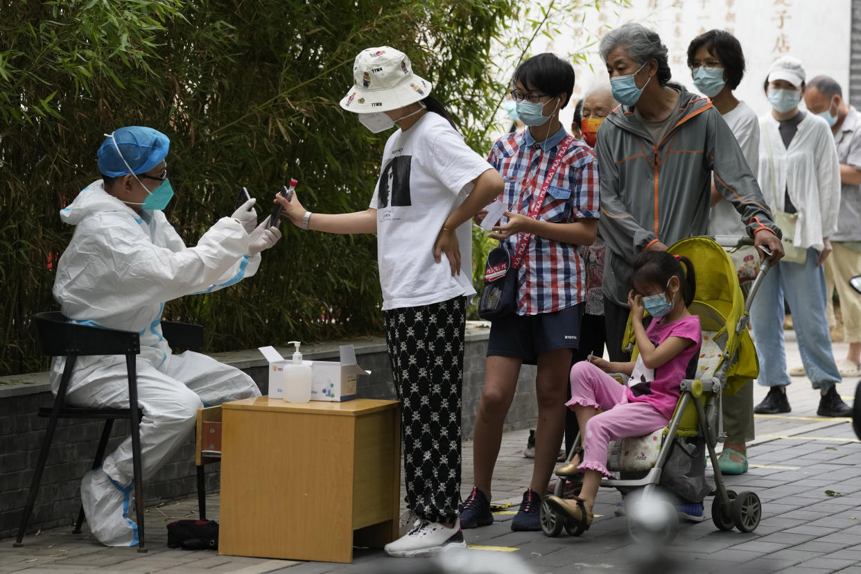 Residents line up for mass COVID tests, Monday, June 13, 2022, in Beijing. (AP Photo/Ng Han Guan)