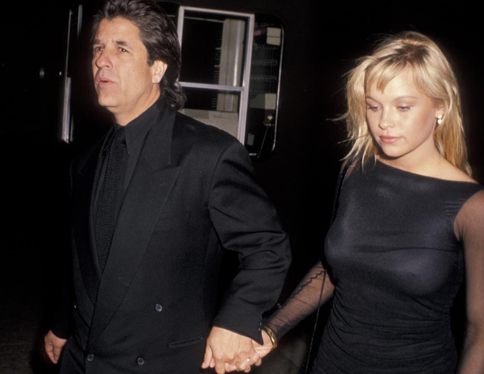 Jon Peters and Pamela Anderson attending a premiere in 1989 (Credit: Getty Images)