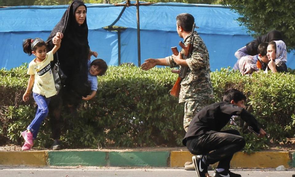 Soldiers and families run from Saturday’s attack in Ahvaz.