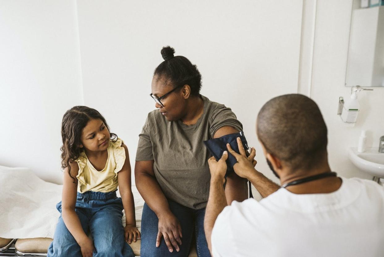 Raising the cost barriers for health care will harm the most vulnerable patients. <a href="https://www.gettyimages.com/detail/photo/mother-talking-with-daughter-while-male-doctor-royalty-free-image/1321467310" rel="nofollow noopener" target="_blank" data-ylk="slk:Maskot via Getty Images;elm:context_link;itc:0;sec:content-canvas" class="link ">Maskot via Getty Images</a>
