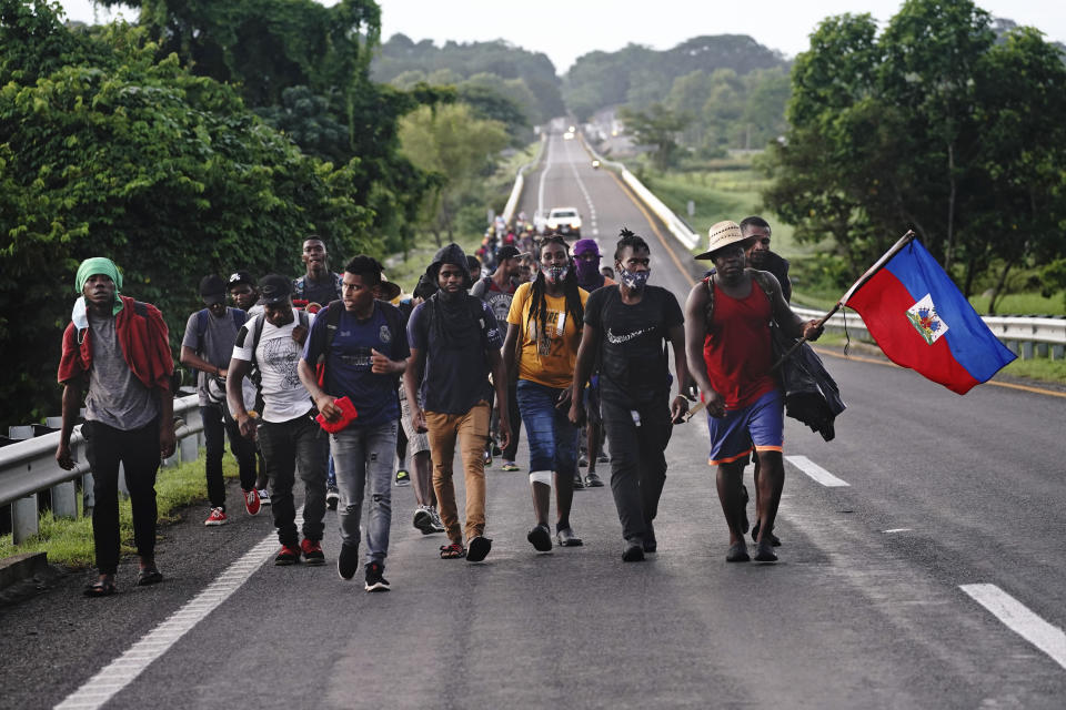 Haitian migrants walk along the highway in Huixtla, Chiapas state, Mexico, early Thursday, Sept. 2, 2021, in their journey north toward the U.S. (AP Photo/Marco Ugarte)