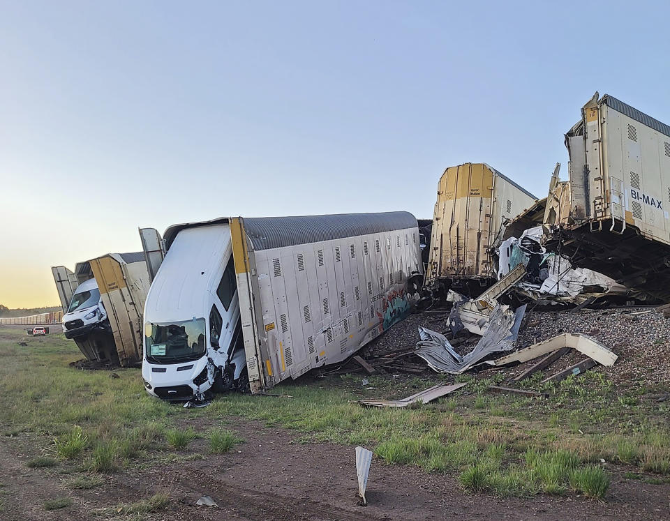 This image provided by the Coconino County Emergency Management shows vehicles damaged as a result of a freight train derailment, Wednesday, June 7, 2023 east of Williams, Ariz. (Coconino County Emergency Management via AP)