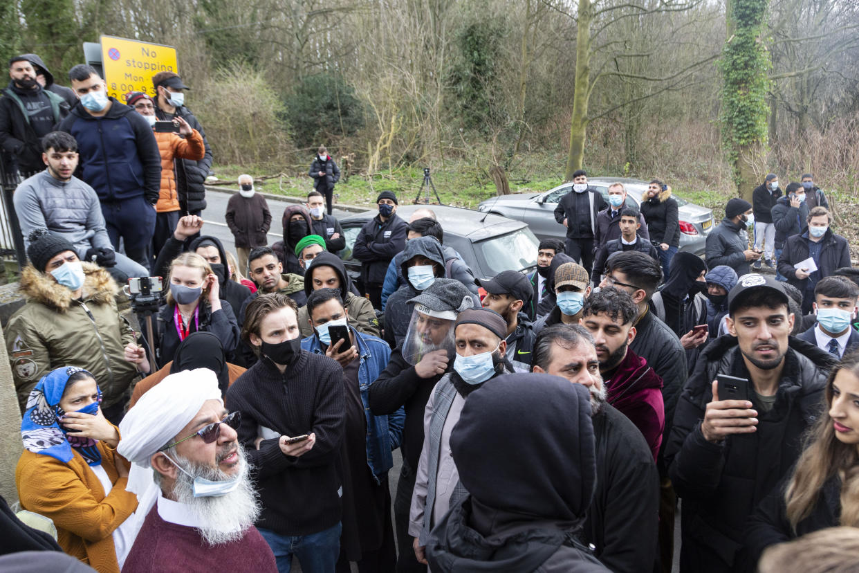 A local community leader speaks to the crowd of parents. Angry parents are protesting outside a Batley Grammar School, West Yorks, after a teacher allegedly showed derogatory caricatures of the Prophet Muhammad, pictured in West Yorks, March 25 2021. See SWNS story SWLEprotest.