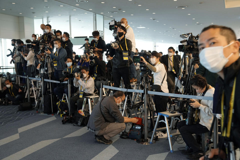 Journalists wait for Japan's former Princess Mako, the elder daughter of Crown Prince Akishino, and her husband Kei Komuro, to arrive to board an airplane to New York Sunday, Nov. 14, 2021, at Tokyo International Airport in Tokyo. (AP Photo/Eugene Hoshiko)