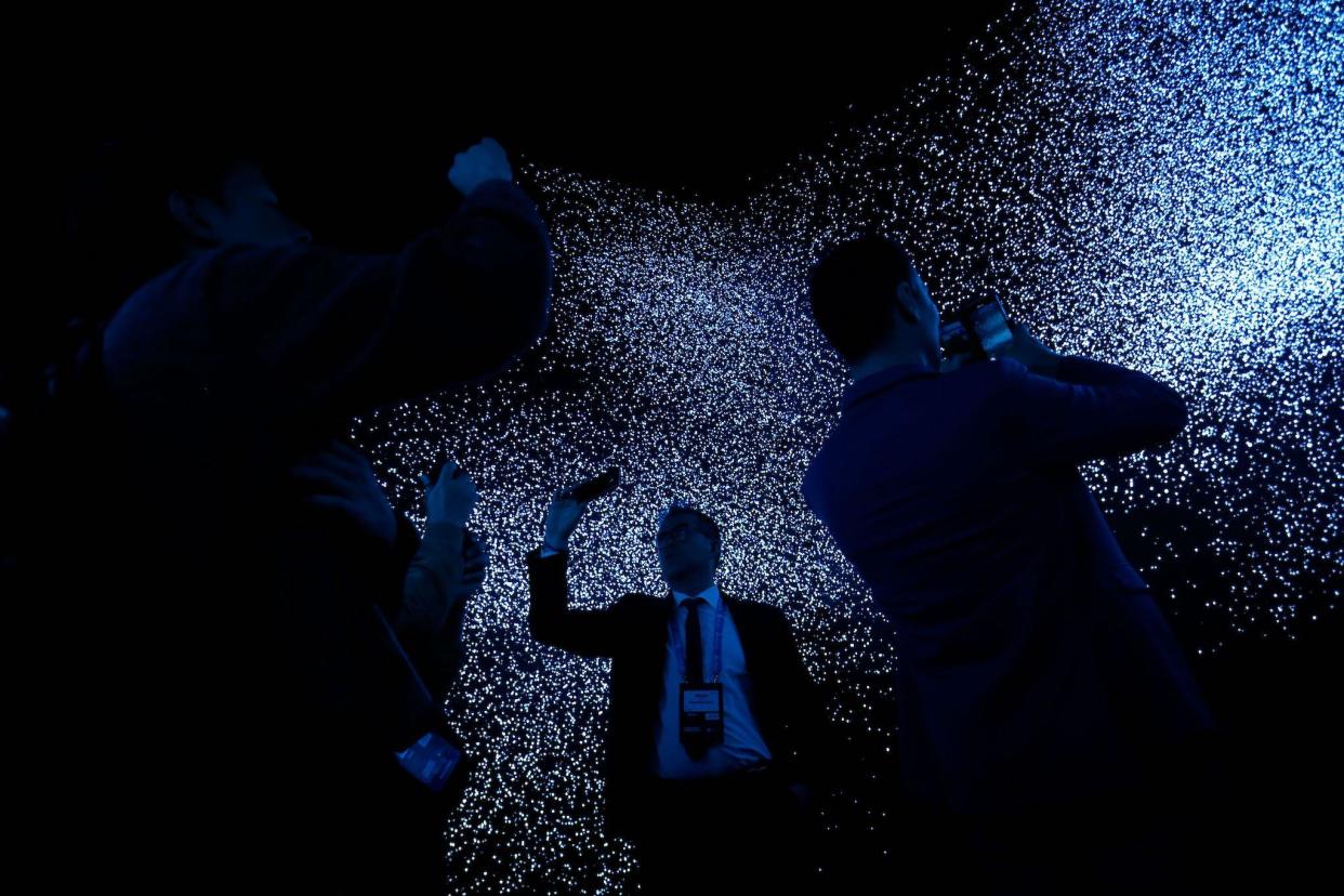 People visit the Qualcomm stand at the Mobile World Congress (MWC) in Barcelona on February 26, 2019: PAU BARRENA/AFP via Getty Images