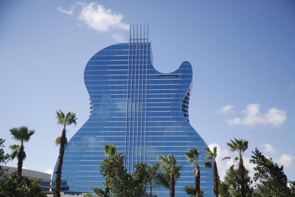 The guitar shaped hotel is seen at the Seminole Hard Rock Hotel and Casino on Thursday, Oct. 24, 2019, in Hollywood, Fla. The Guitar Hotel's grand opening is on the tribe's land in Hollywood. It's the latest step in the Seminole Hard Rock empire, which includes naming rights on the Miami-area stadium where the 2020 Super Bowl will be played. (AP Photo/Brynn Anderson)