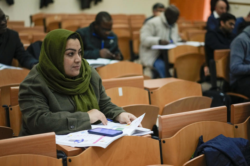 Batool Haidari, 37, attends an Italian language class, in Rome, Monday, Dec. 5, 2022. Batool Haidari was a prominent professor of sexology at a university in Kabul before last year’s Taliban takeover of Afghanistan. She used to lecture mixed classes of male and female students and look after her patients struggling with their gender identity. That comfortable life came to an abrupt halt on Aug. 15, 2021, when the ultra-religious group swept back into power. (AP Photo/Andrew Medichini)